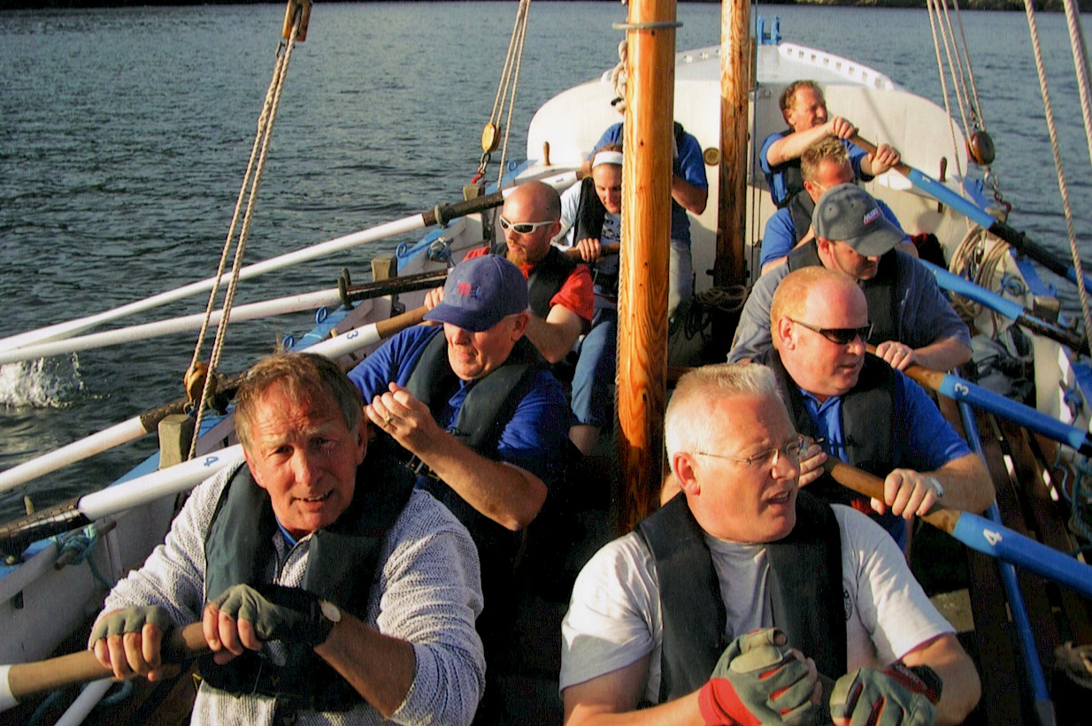 Colour shot of the restored Ryder crew rowing the boat
