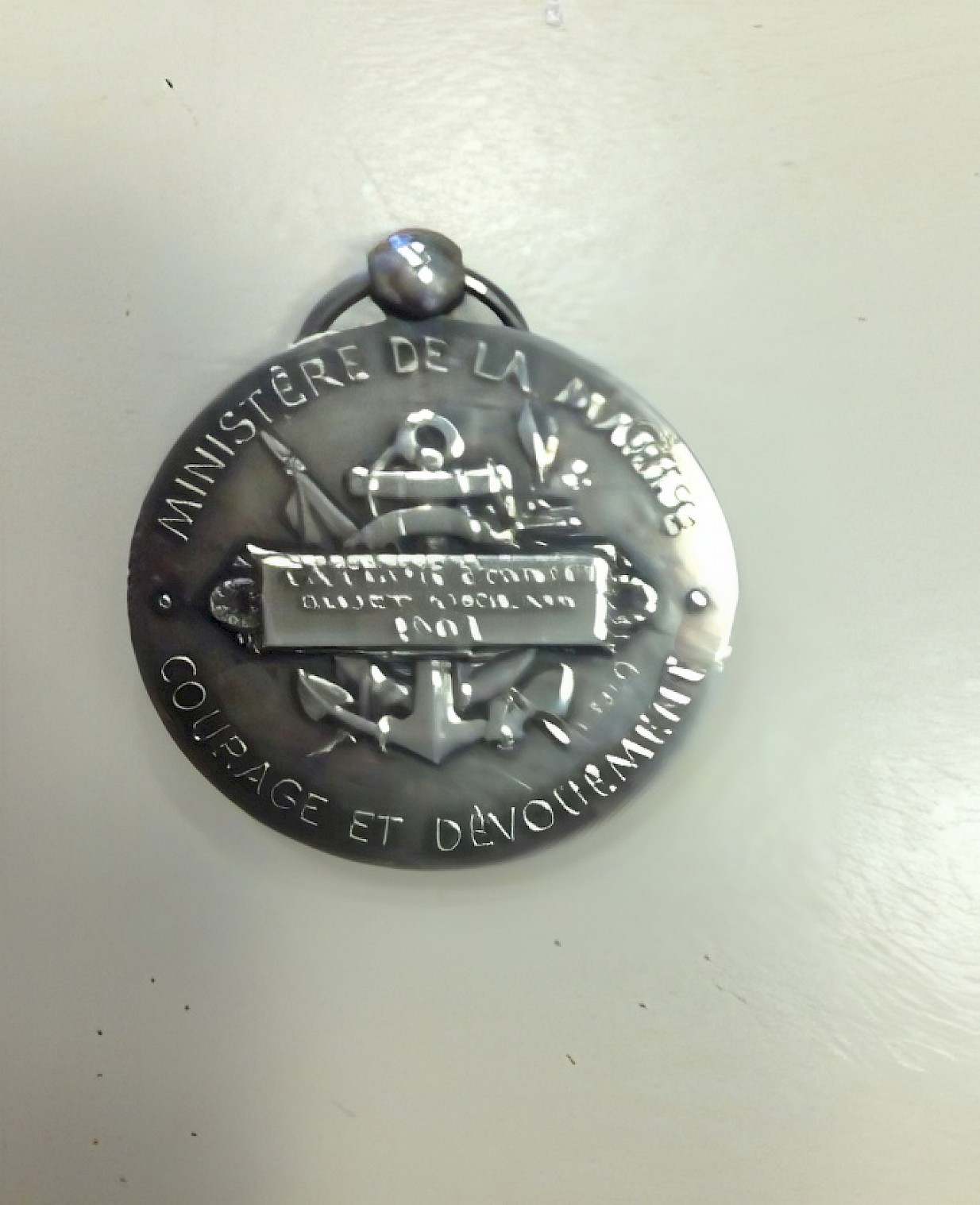 Medal with anchor motif and lettering