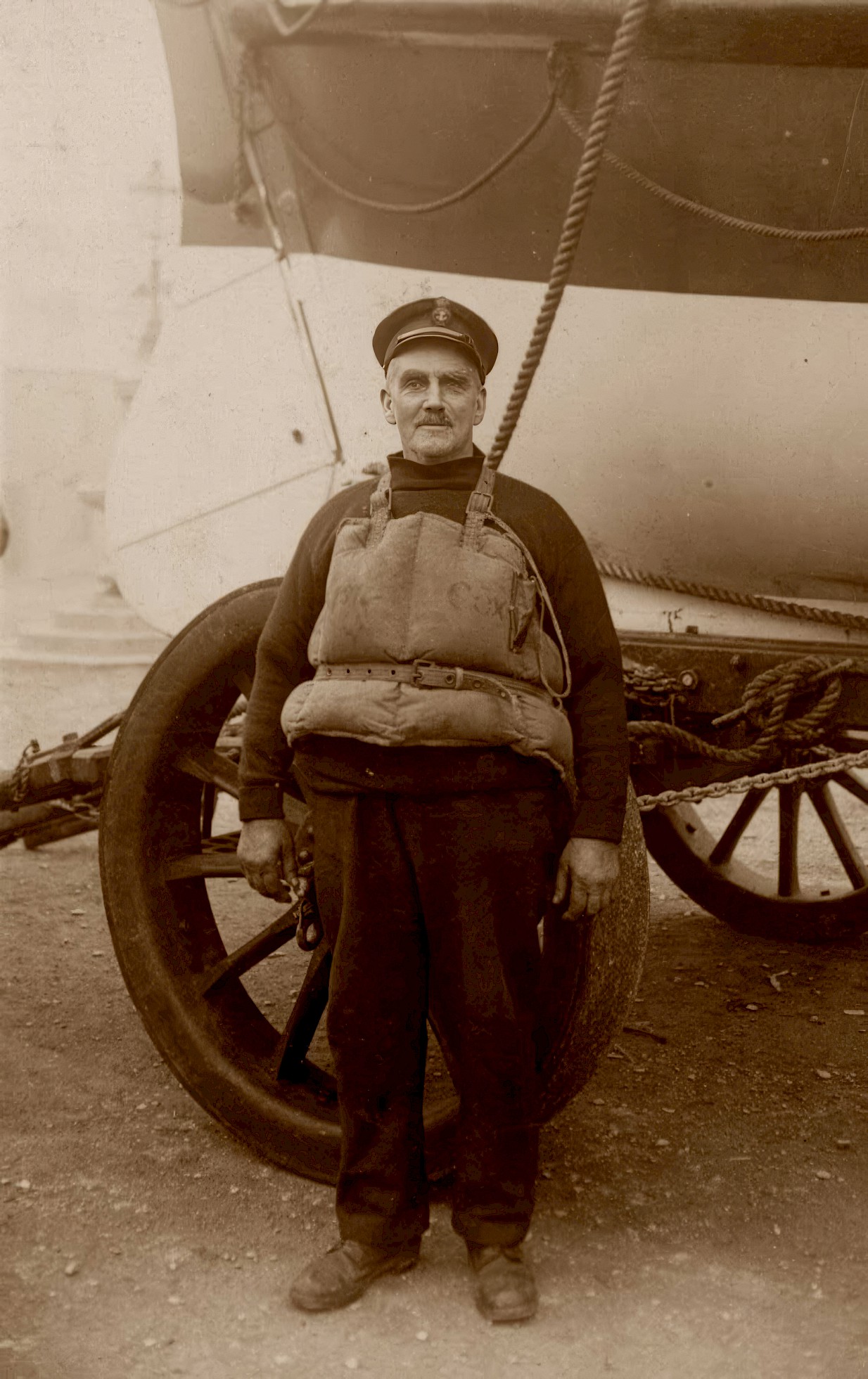 W Thomas Toms stands in front of Ryder wearing a life jacket
