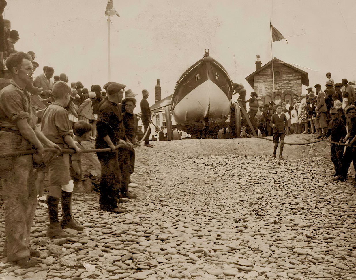 Crowds watch as preparations are made to haul Ryder to the sea